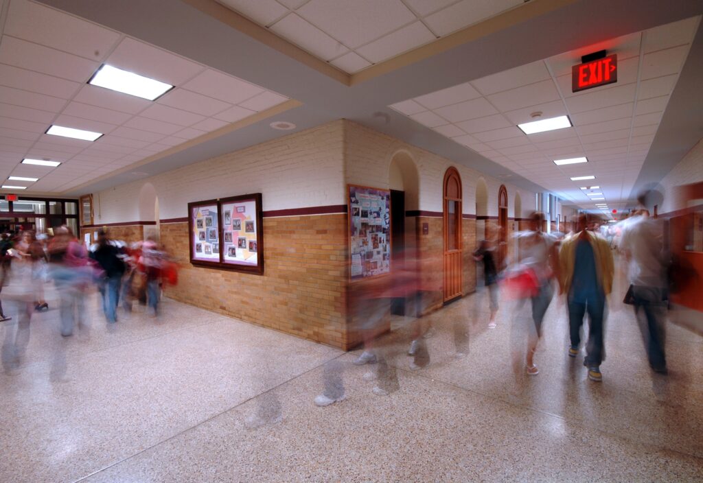 School hallway as students and staff move quickly to the next class on their schedule.
